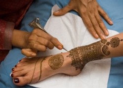 Ankle getting henna tattoo